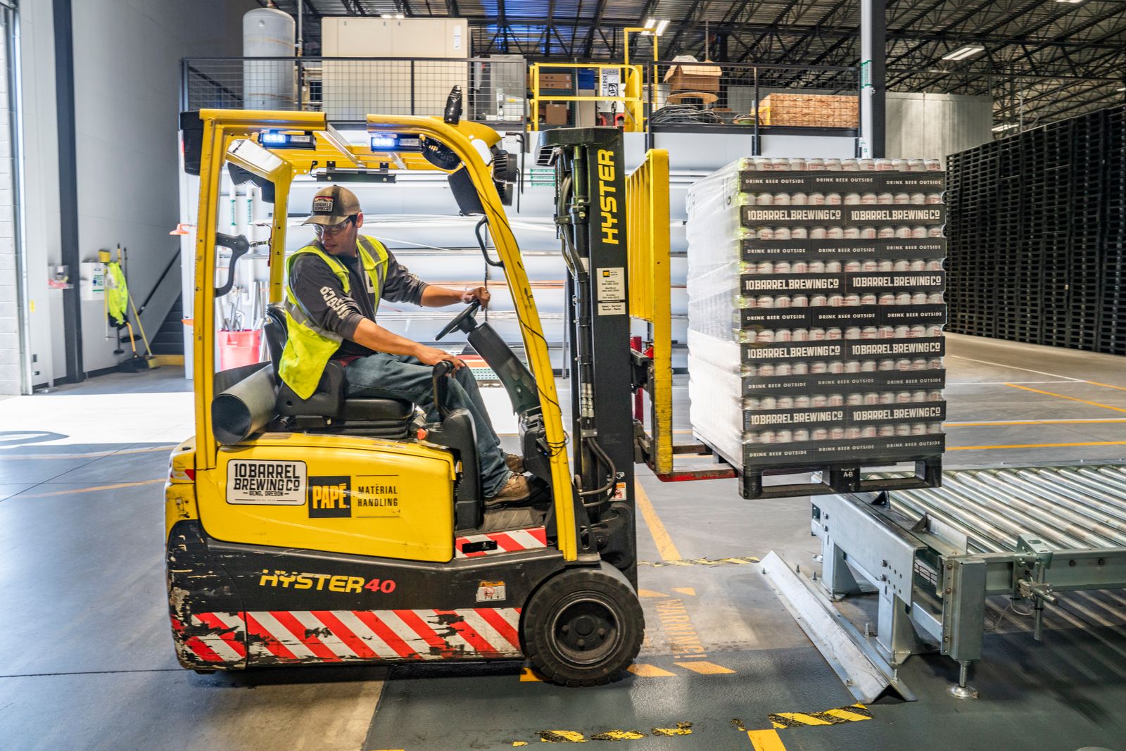 Forklift moving palletised materials inside a warehouse